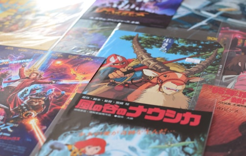 A collection of colorful, illustrated posters featuring various animated and fantasy themes. The designs include characters and imaginative creatures with vibrant backgrounds, showcasing diverse styles and themes.