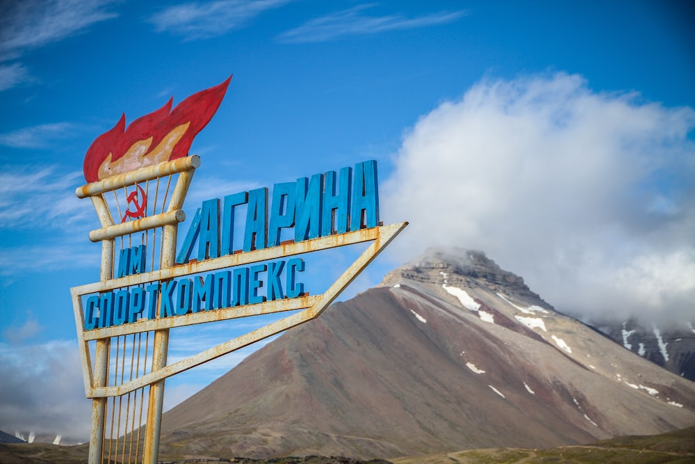 blue signage near mountain