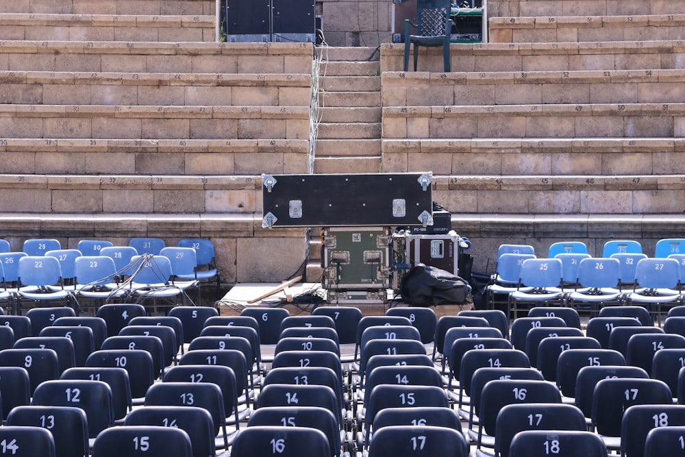 empty blue chairs in coliseum