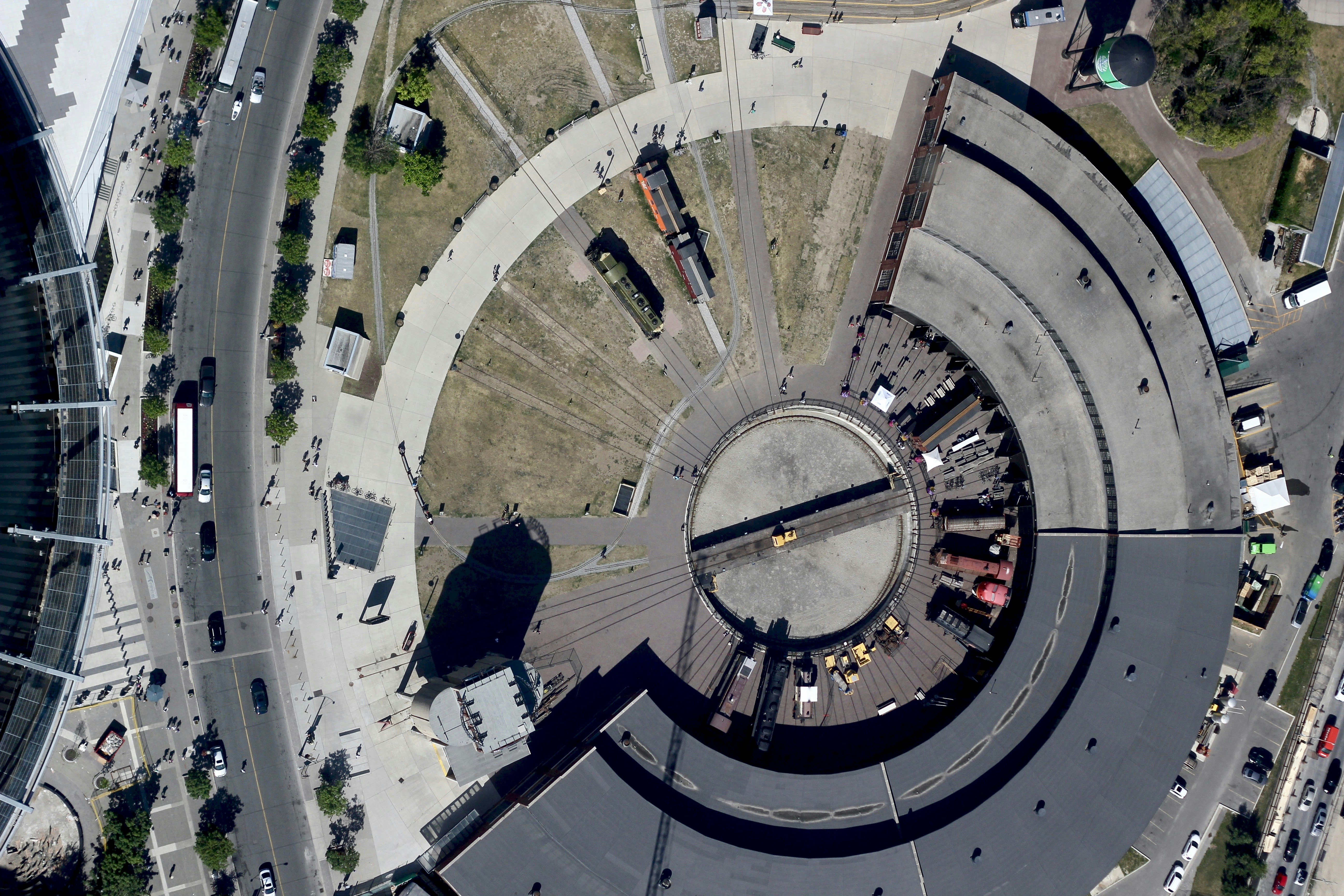 Aerial view of circular railway spiral viaduct with red train completing full loop
