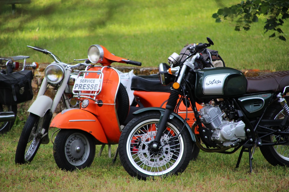two motorcycles parked next to each other in a field