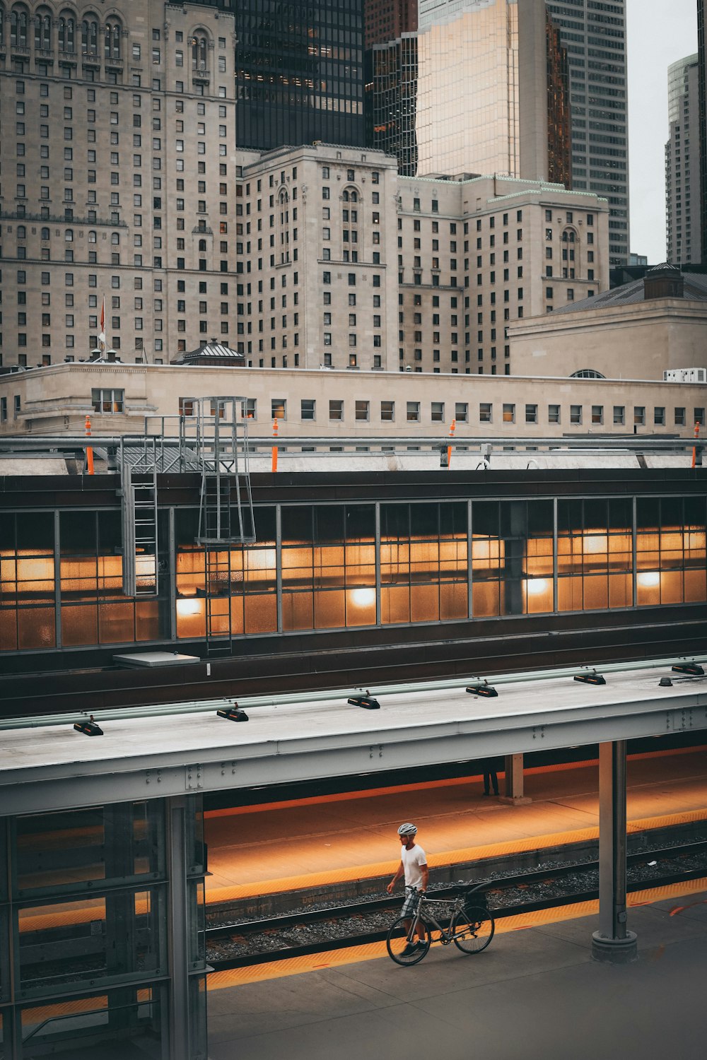 a person riding a bike near a train station