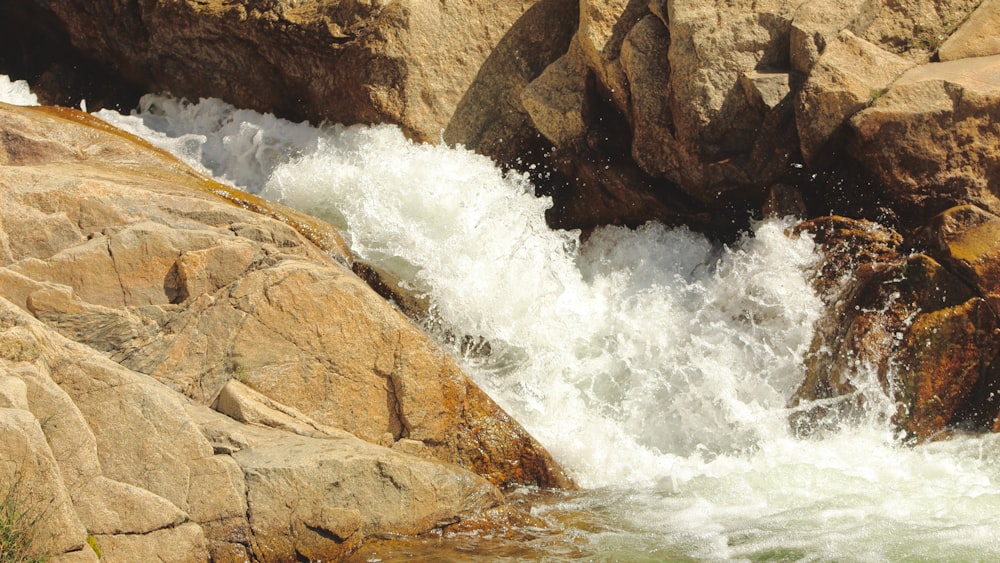 a man riding a surfboard on top of a river