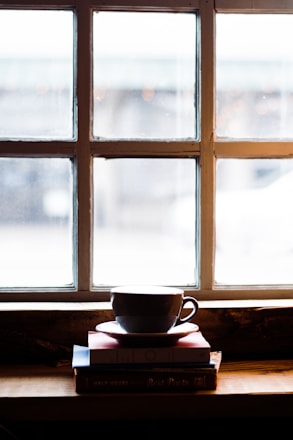 A serene workspace with soft lighting, open books, and a cup of tea symbolizing calm learning.