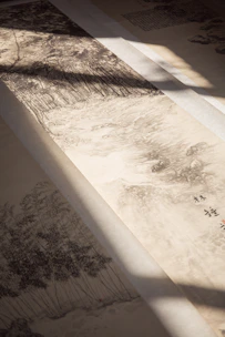 Close-up of traditional Chinese brush and ink on textured rice paper, evoking calm creativity.
