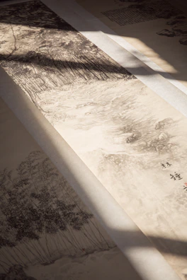 Close-up of delicate brushstrokes on a serene landscape painting with subtle black accents.
