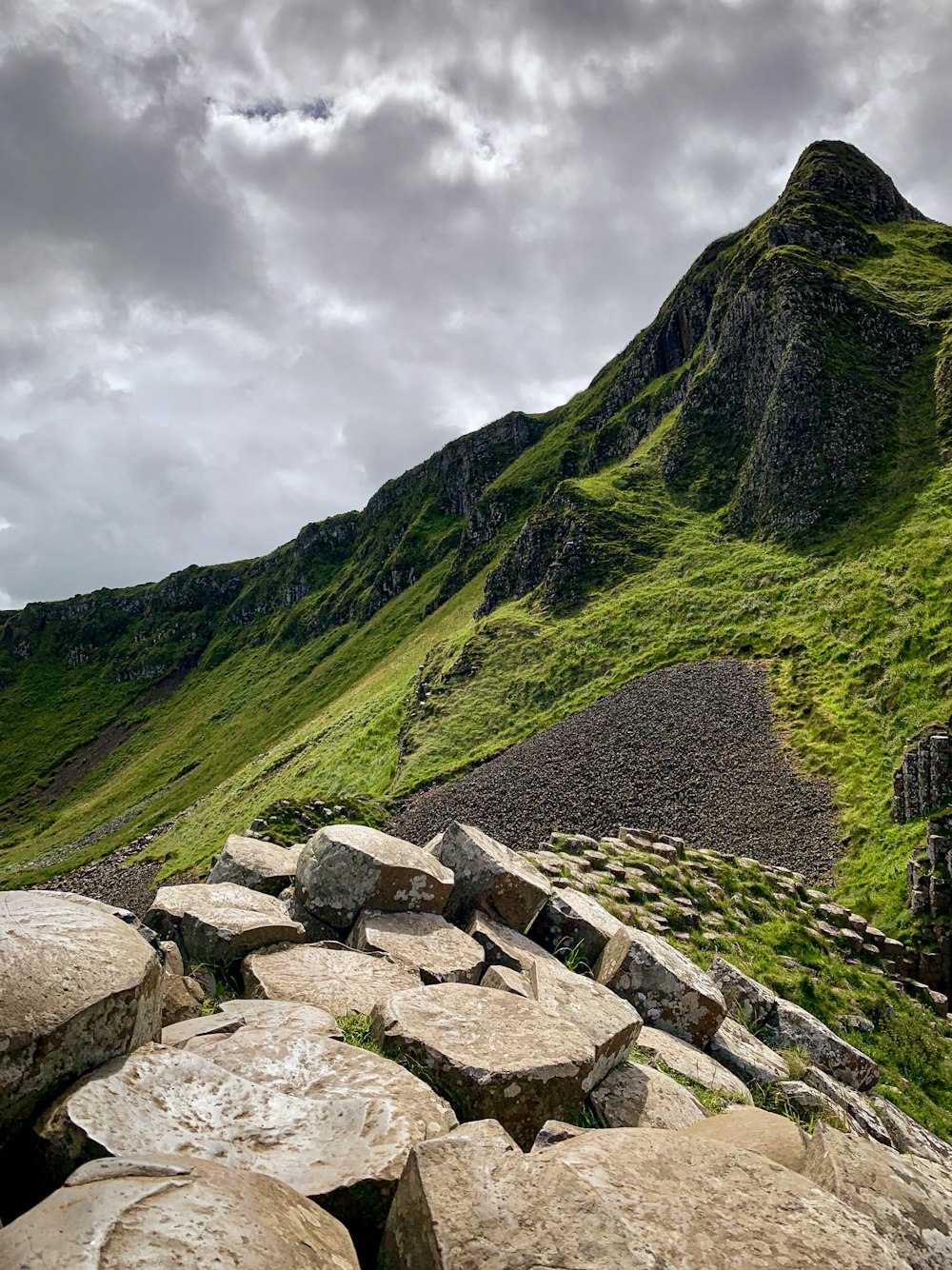 green mountain under cloudy sky