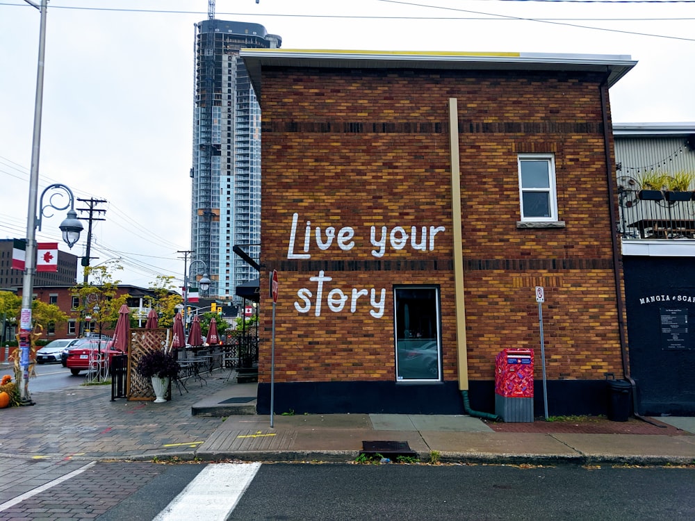 a brick building with writing on the side of it