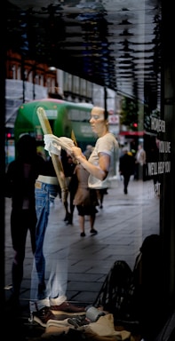 A friendly cleaner wiping a sparkling window with a cloth in a cozy home setting.