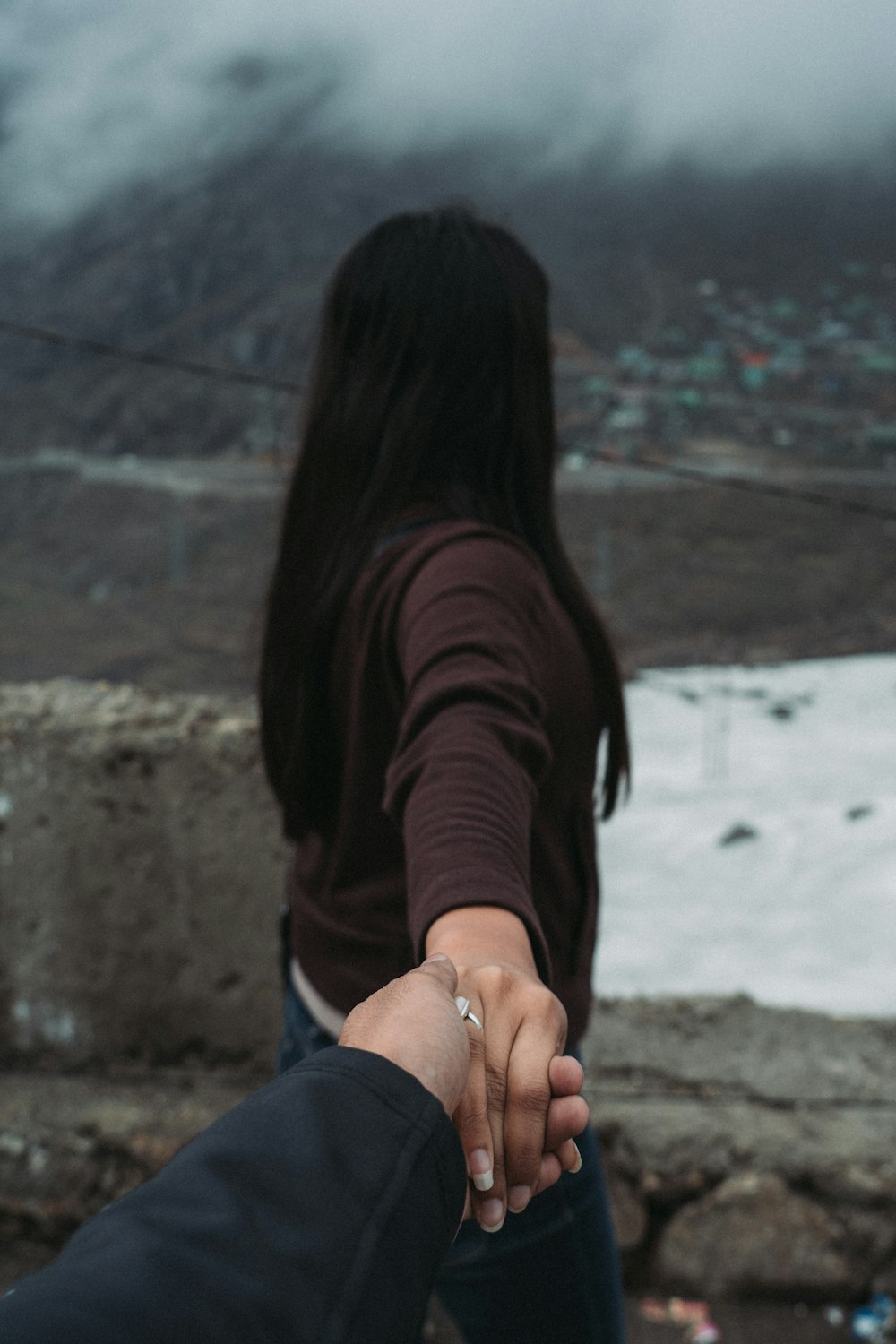 person holding woman's right hand