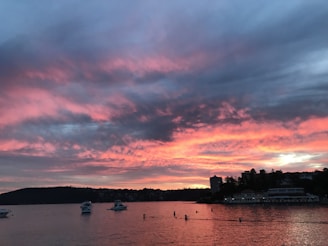 A vibrant sunset over Acapulco bay with colorful boats and lively atmosphere.