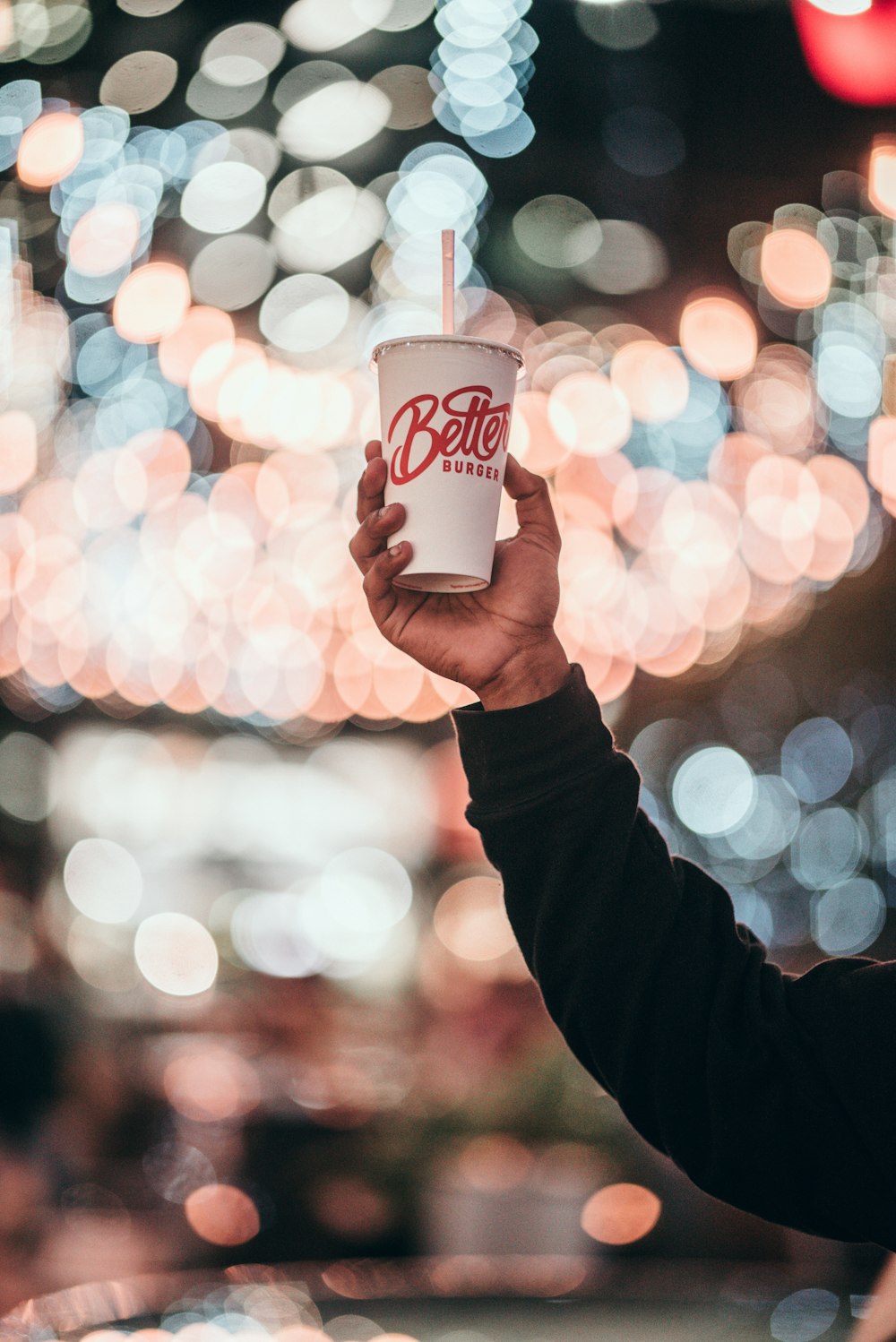 person holding white cup