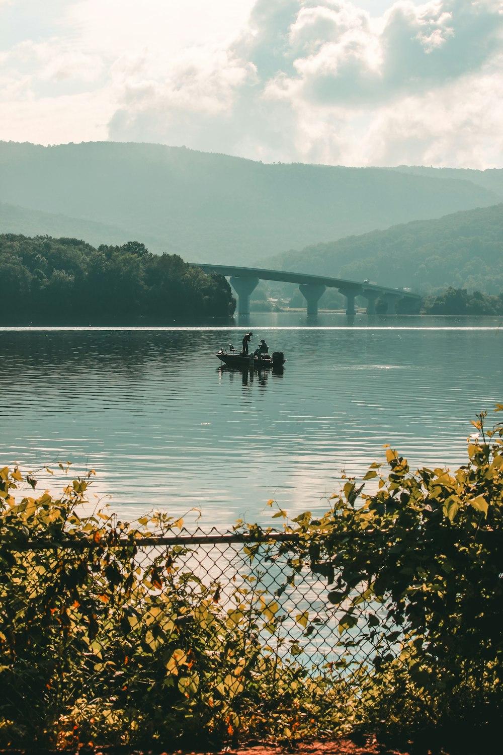 2 person in boat on body of water during daytime