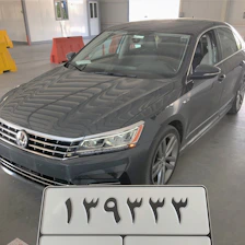 A sleek Japanese car ready for export, parked in a clean, modern warehouse.