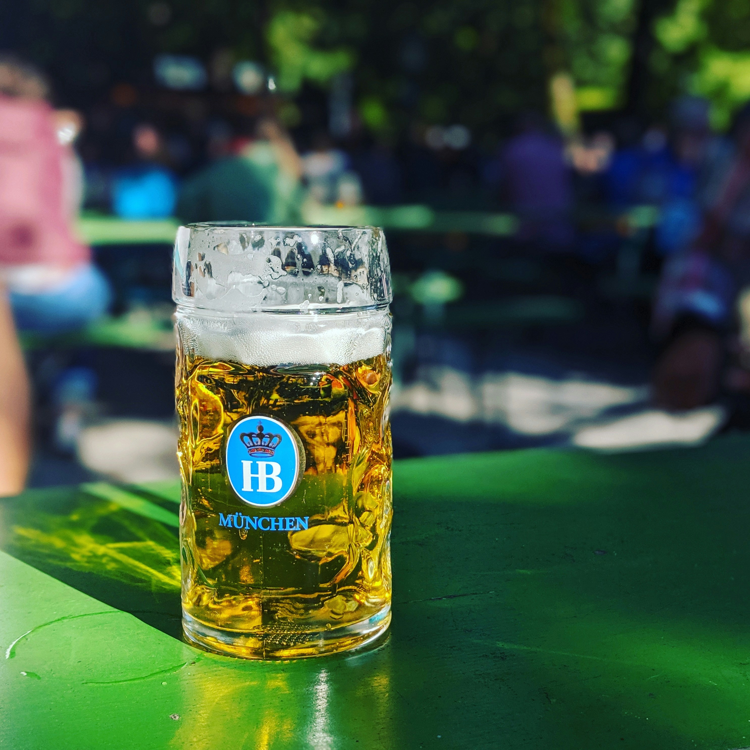 near full Munchen drinking glass on green surface