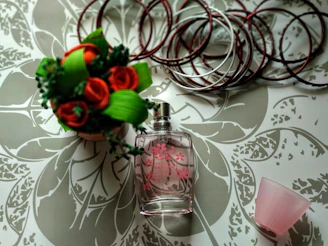 clear glass perfume bottle on white and gray surface