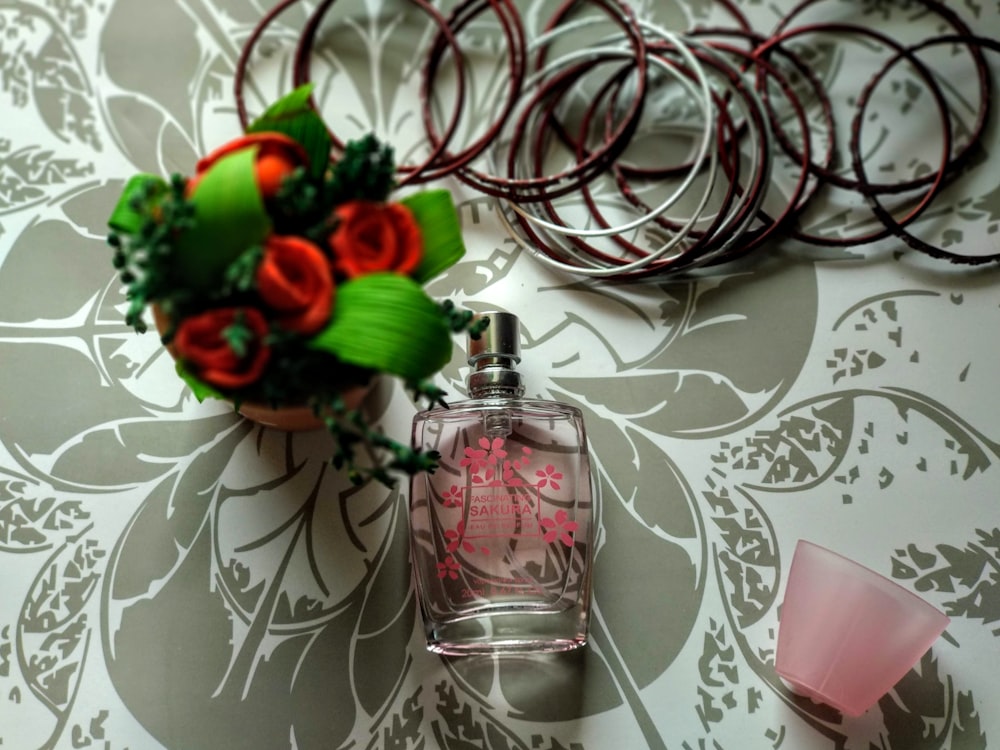 clear glass perfume bottle on white and gray surface