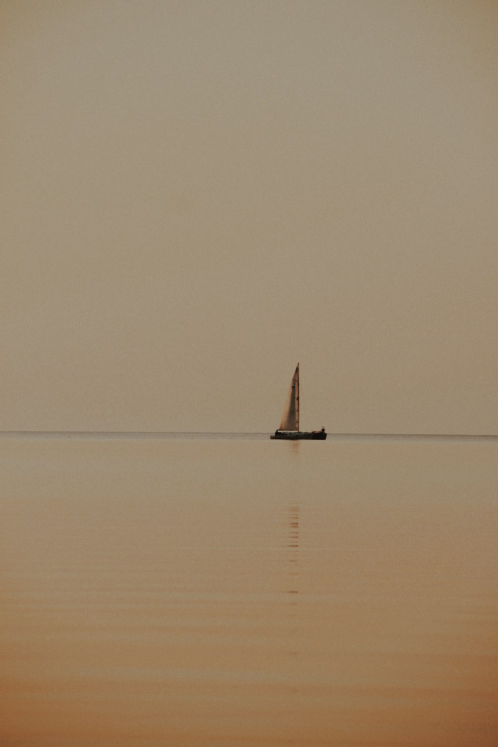 sailboat floating at the sea during day