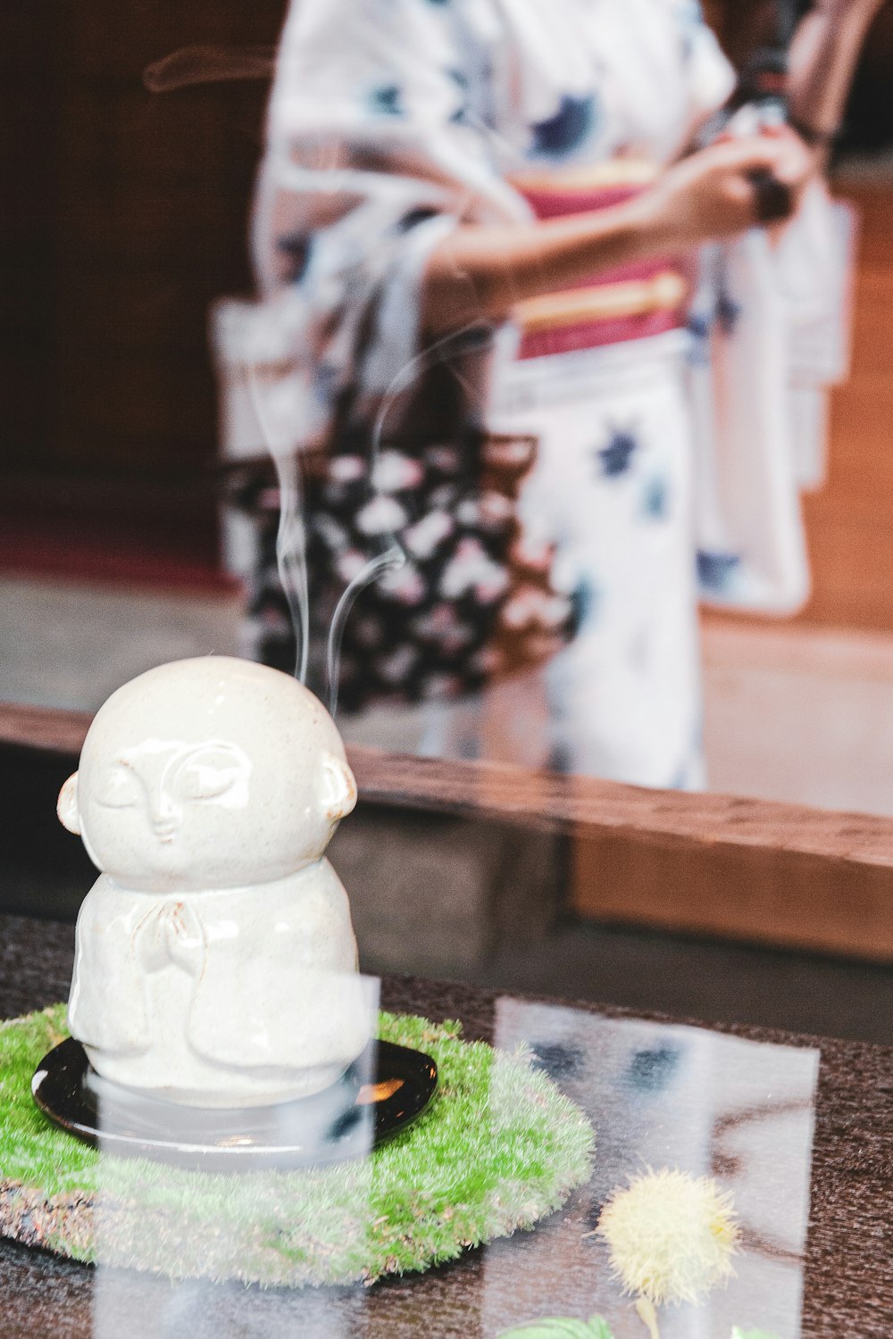 white figurine on clear glass table