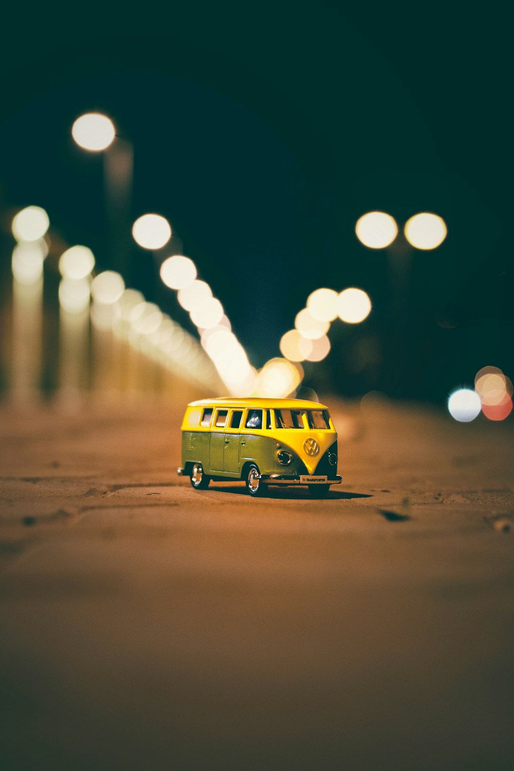 yellow and green Volkswagen van die-cast on ground