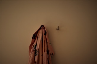 Adhesive curtain hooks holding lightweight fabric curtains on a bright kitchen window.