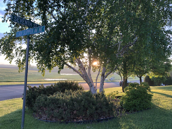 A calm, inviting street corner in Medford at sunset, hinting at a quiet, reliable ride service nearby.
