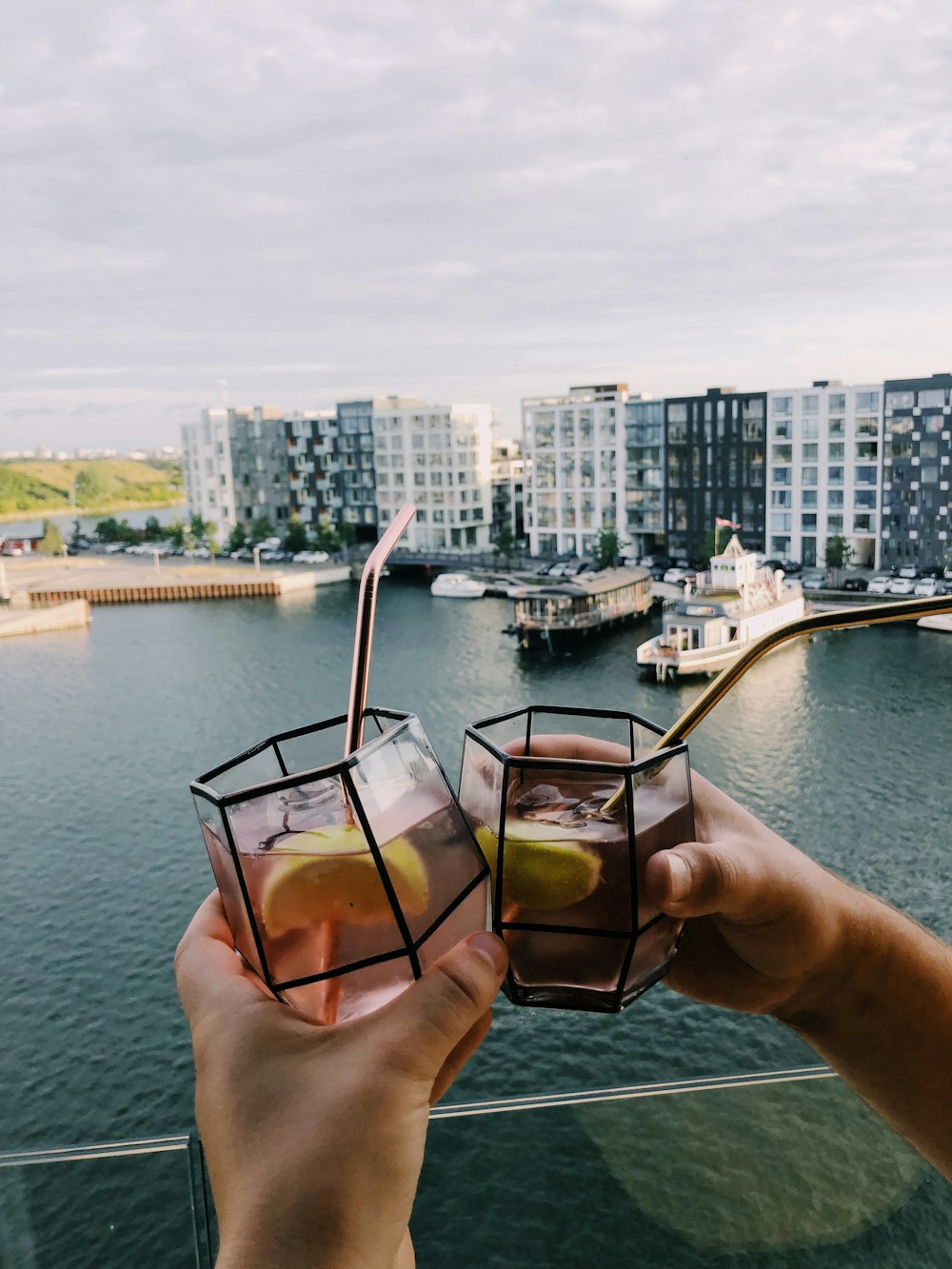 person holding glass of cocktails