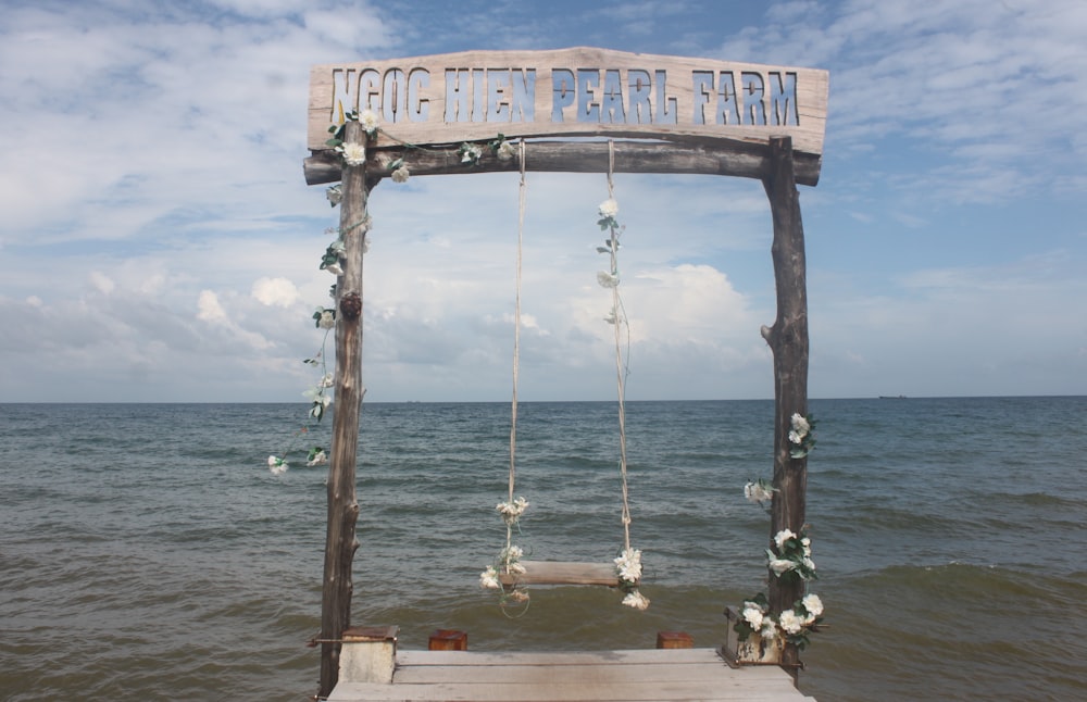 brown swing on dock during daytime