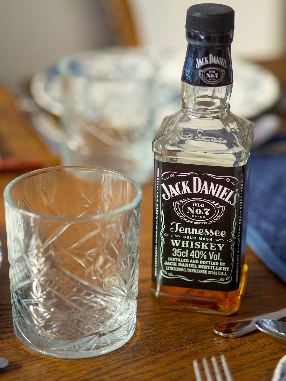 empty cup beside Jack Daniel's bottle
