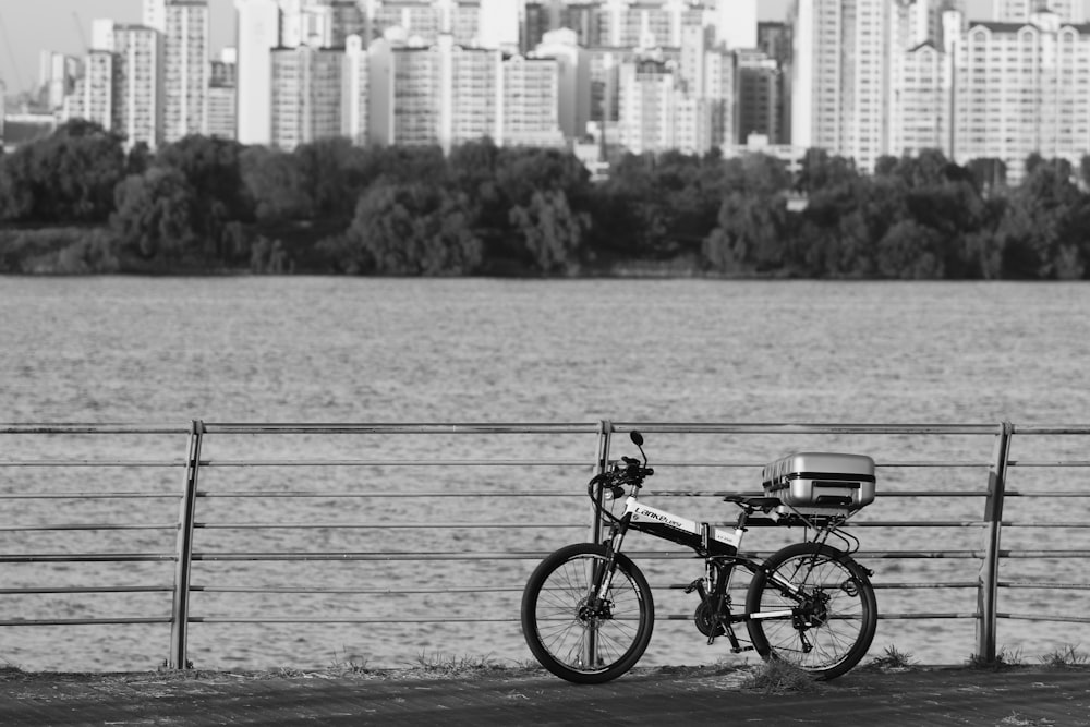 black bike leaning on railing