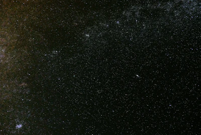 A panoramic view of the cosmos above Ebonyr, dotted with distant galaxies and nebulae.