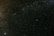 A vast starry sky filled with countless stars and cosmic dust, with a slightly visible nebula or galaxy in the distance creating a mysterious and expansive atmosphere.