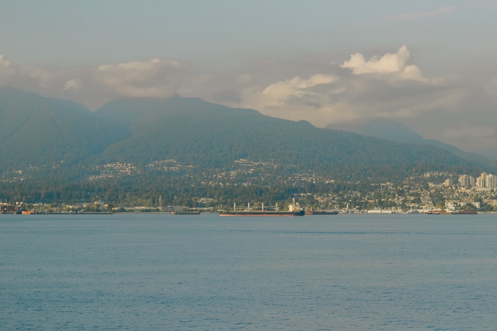 aerial photography ofgreen mountains by the sea during daytime