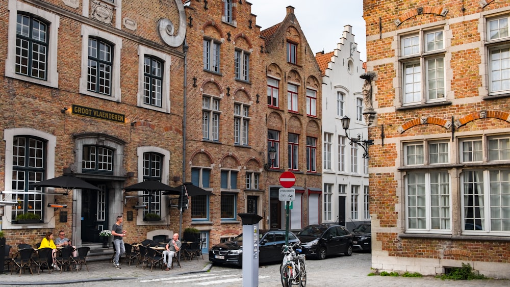 person sitting beside building during daytime