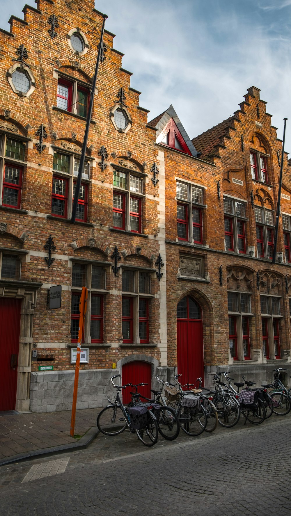 a row of bicycles parked in front of a building