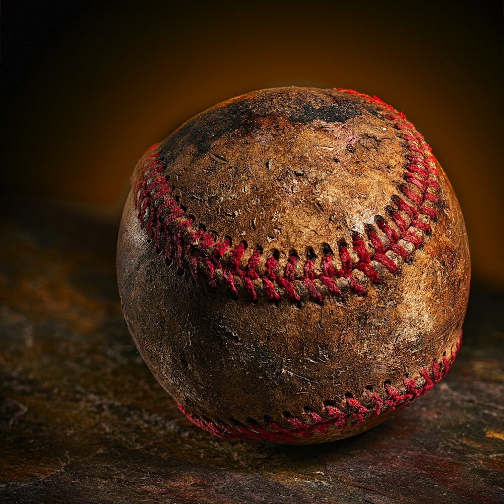 brown baseball ball on brown surface