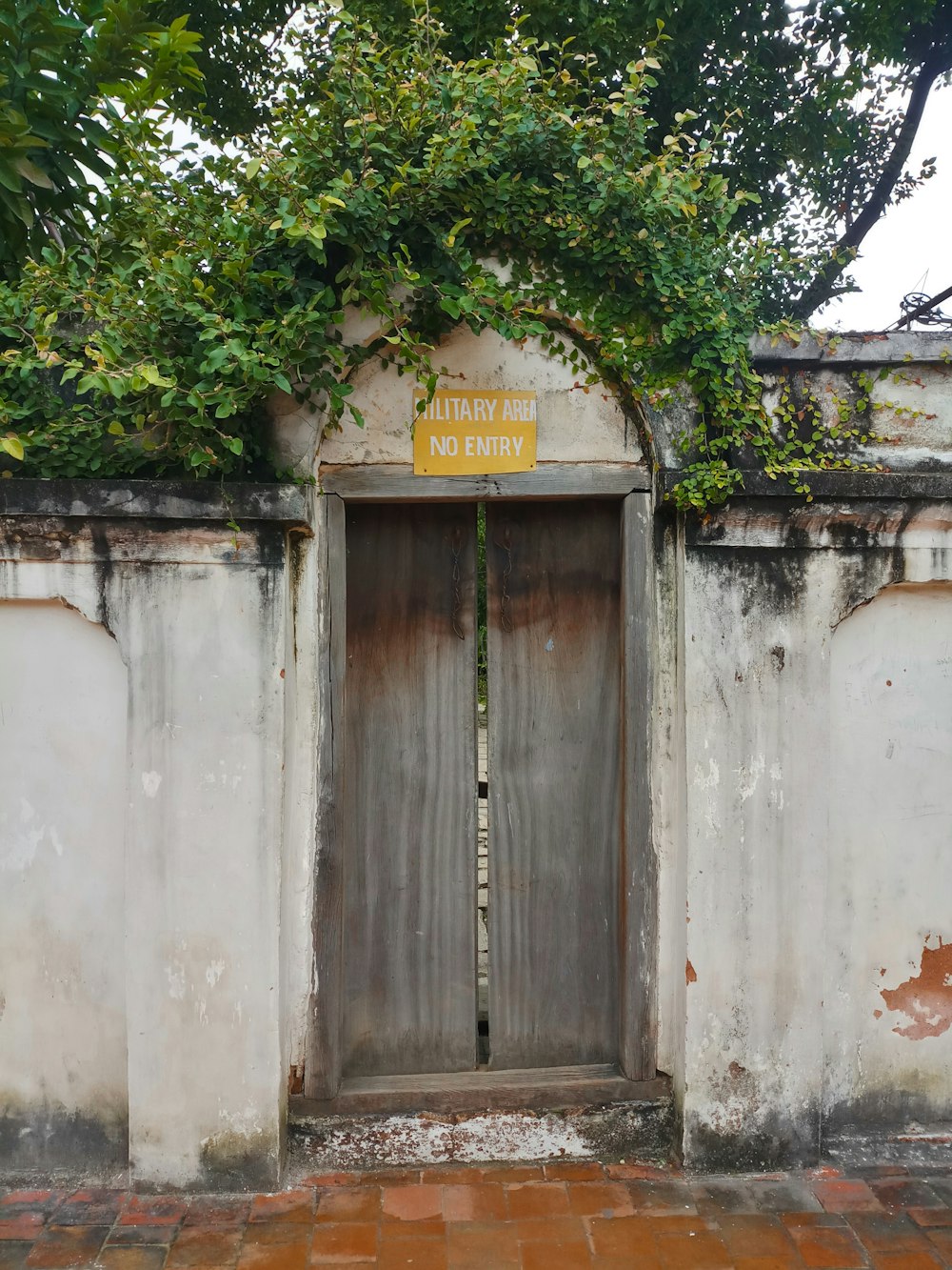 an old building with a door and a sign on it