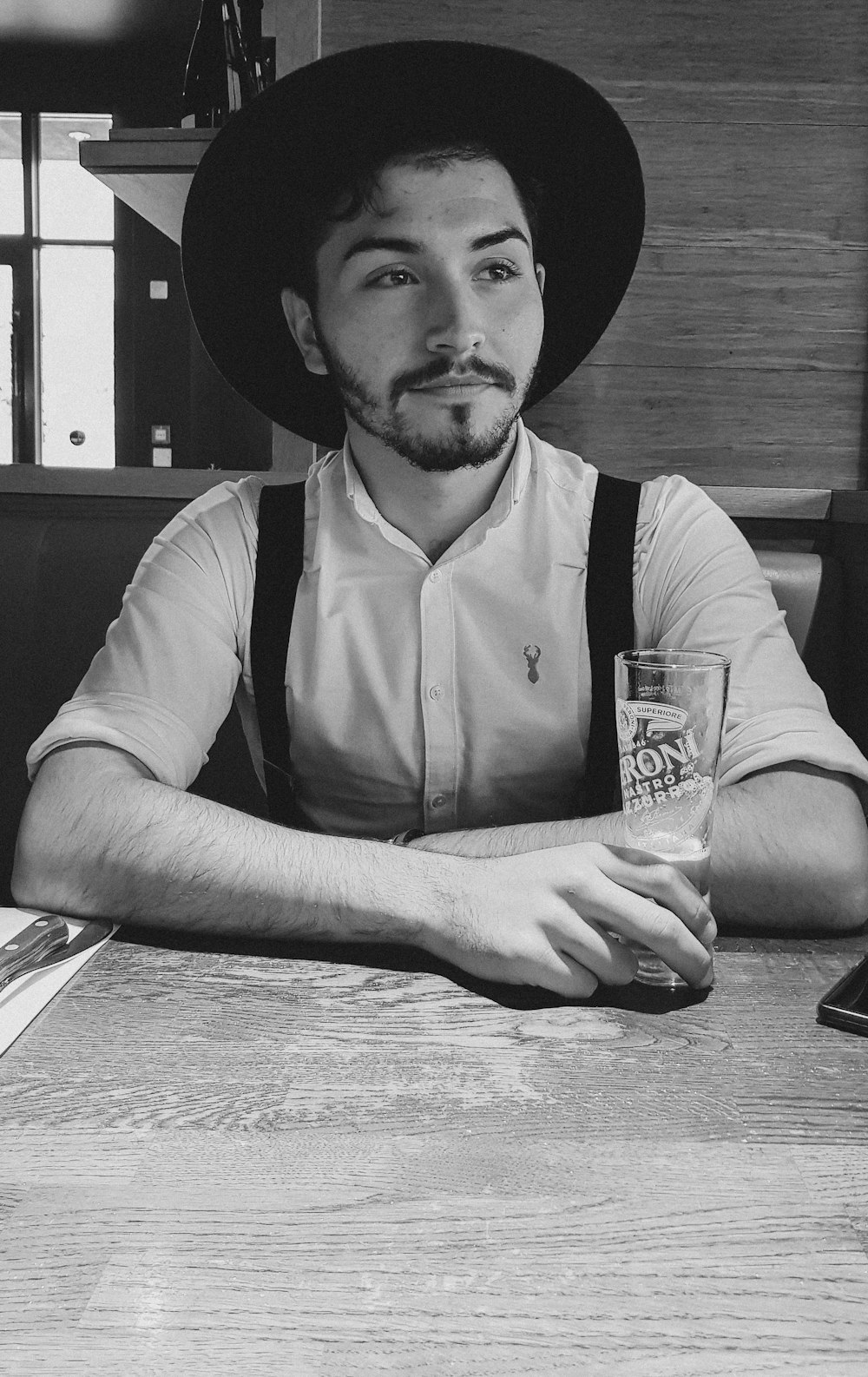 grayscale photography of man wearing hat