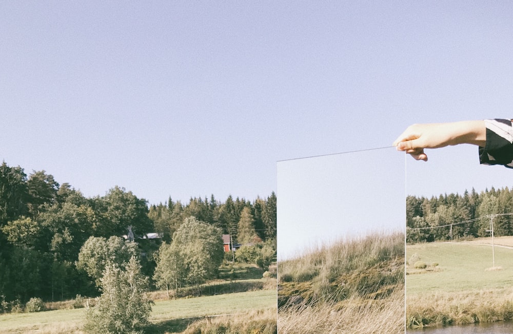 person holding mirror during daytime