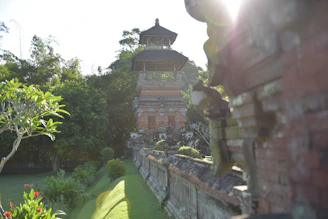 An old photograph of the ancestral zamindar estate in Bangarhatta village, showcasing traditional architecture surrounded by lush greenery.