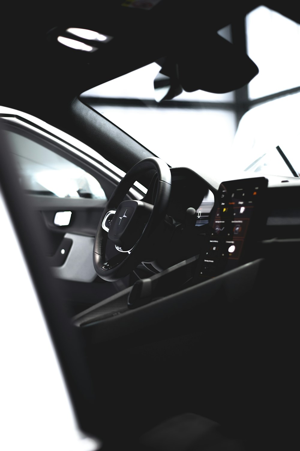 the interior of a car with a steering wheel and dashboard