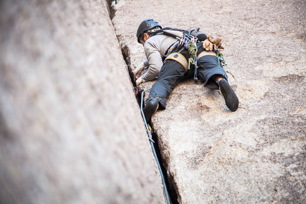 man climbing rock mountain