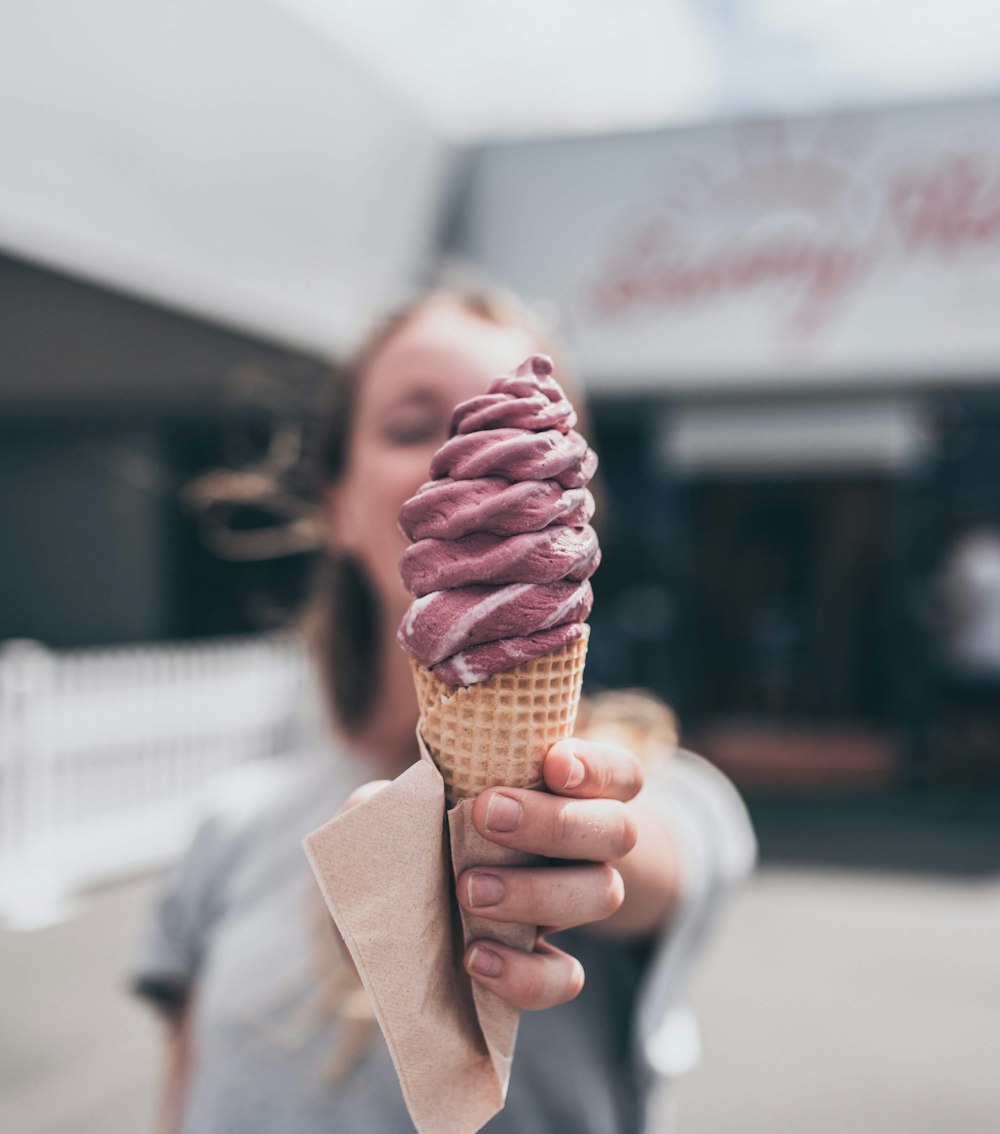 brown ice cream on brown cone with tissue