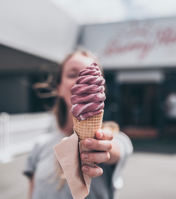 Brown ice cream on brown cone with tissue