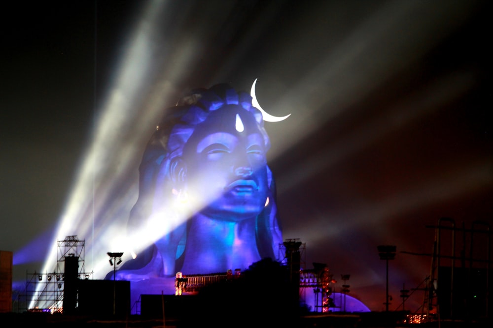 a large statue of a woman with a crescent on it's head