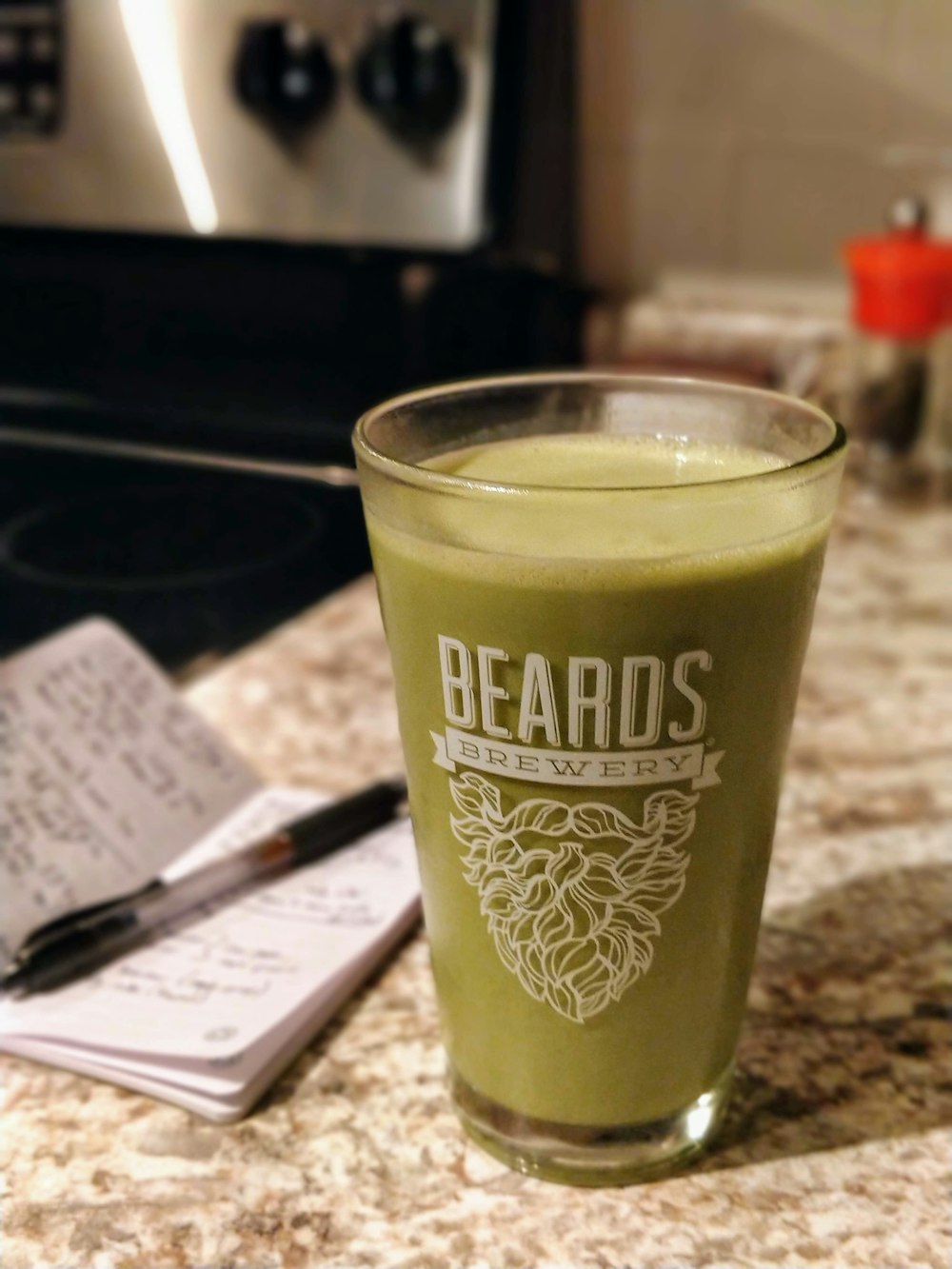 Beards Brewery-printed drinking glass with green liquid