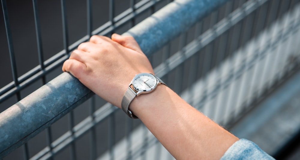round silver-colored analog watch with link bracelet
