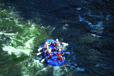 people in raft on river