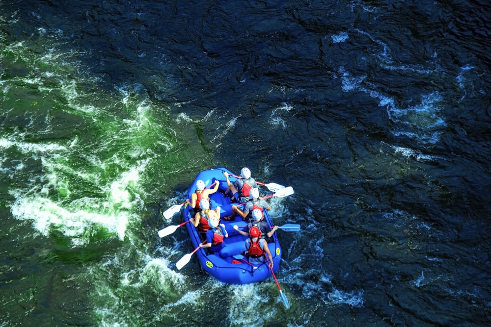 people in raft on river