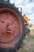 Close-up of a tractor tire filled with liquid ballast on a sunny farm field.